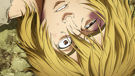 Thorfinn lies against the ground with a strained expression.